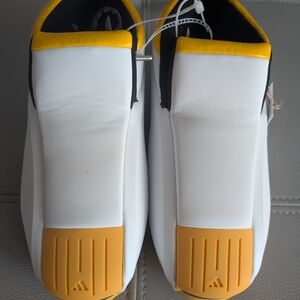 White and Yellow Athletic Shoes